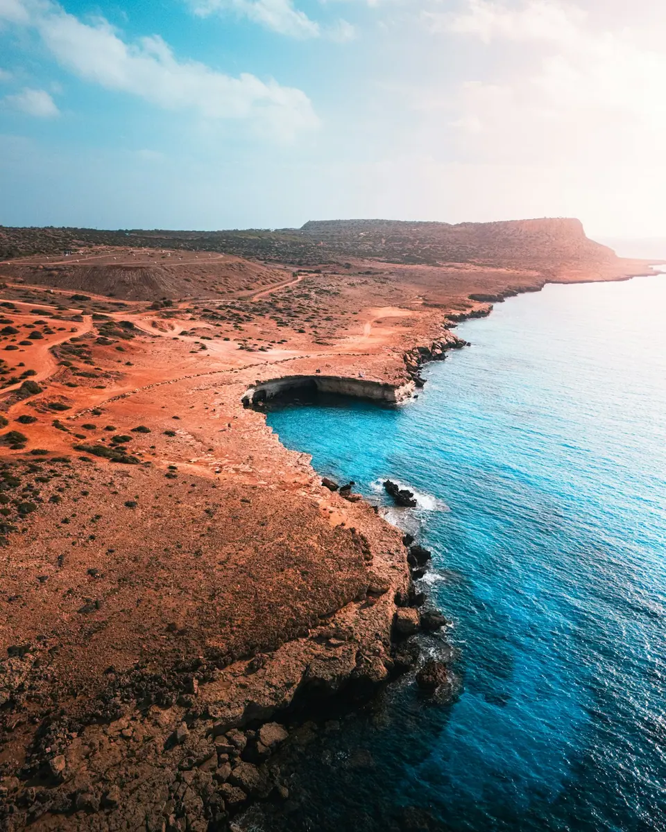 Aerial view of rocky Cyprus coastline and turquoise Mediterranean water